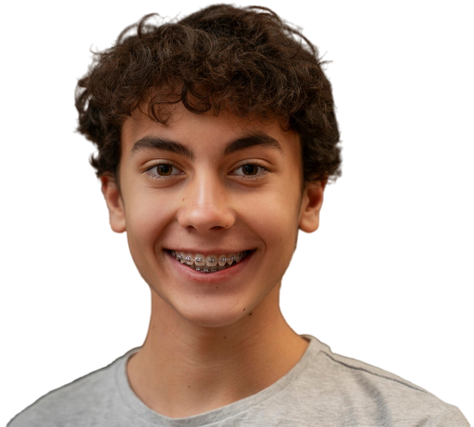 A boy with braces is smiling